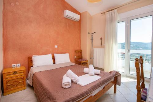 a bedroom with a bed with towels on it at Villa Rafailia in Skala Marion