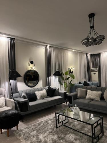 a living room with two couches and a coffee table at Unique villa in madinaty in Madinaty