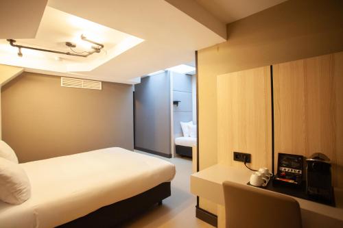 a hotel room with a bed and a bedroom at The Alfred Hotel in Amsterdam