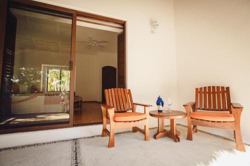 two chairs and a table in a room at Hotel Rancho Encantado in Bacalar