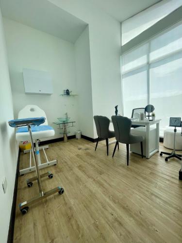 an office with a hospital room with a table and chairs at Hotel Manantial Valencia in Valencia