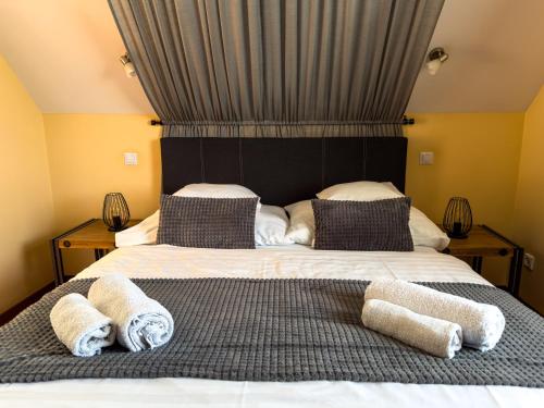 a bedroom with a large bed with towels on it at Barackvirág Vendégház in Tihany