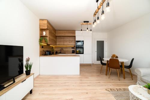 a kitchen and living room with a table and chairs at New BNB Apartment In the Ostrava with parking option in Slezská Ostrava