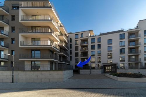 an apartment building with a blue flag in front of it at New BNB Apartment In the Ostrava with parking option in Slezská Ostrava