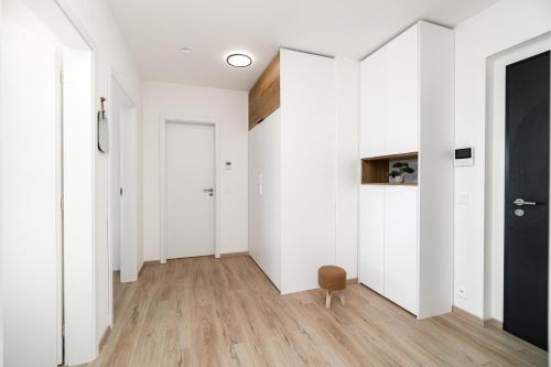 an empty hallway with white walls and wooden floors at New BNB Apartment In the Ostrava with parking option in Slezská Ostrava