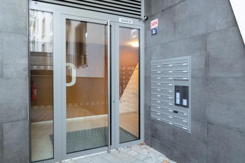 an entrance to a building with a glass door at New BNB Apartment In the Ostrava with parking option in Slezská Ostrava