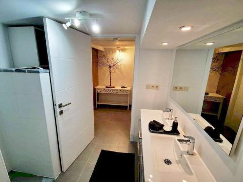 a bathroom with a sink and a mirror at L'Atelier in Houyet