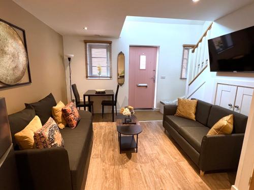 a living room with a couch and a table at Glastonbury Hidden Passage, Split Level 1 Bedroom Apt in Glastonbury