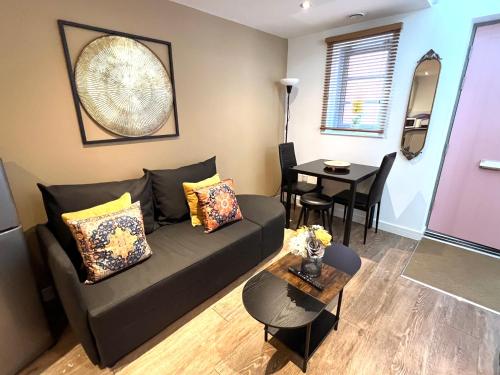 a living room with a couch and a table at Glastonbury Hidden Passage, Split Level 1 Bedroom Apt in Glastonbury