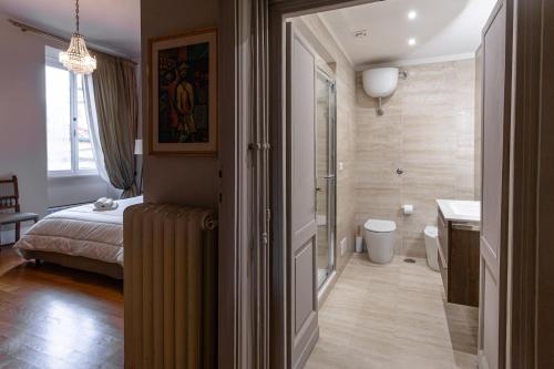 a bedroom with a bed and a bathroom at Vatican Penthouse - Terrace with view in Rome