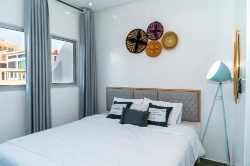 a bedroom with a bed and a clock on the wall at Ocean Charm in Tamraght Ouzdar