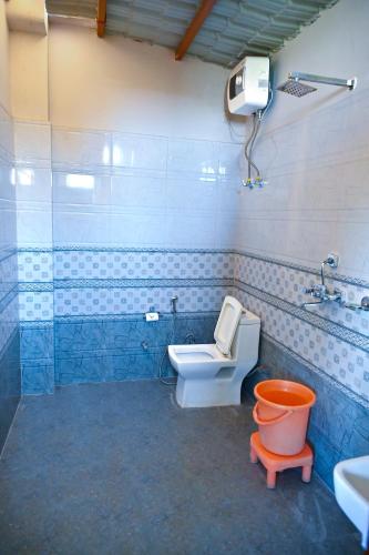 a bathroom with a toilet and a sink at The Bagh Village Resort & Spa in Sawāi Mādhopur