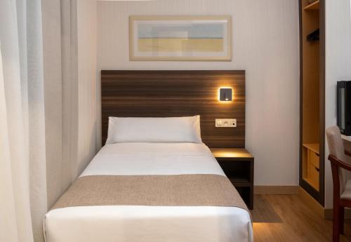Ένα ή περισσότερα κρεβάτια σε δωμάτιο στο Hotel Belcaire