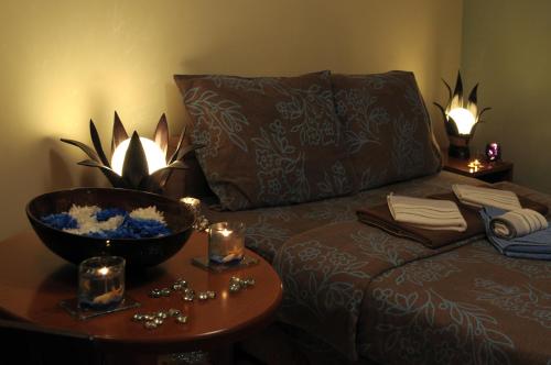 a room with a bed and a table with a bowl on it at IWA CENTAR Apartments & Wellness in Vrnjačka Banja