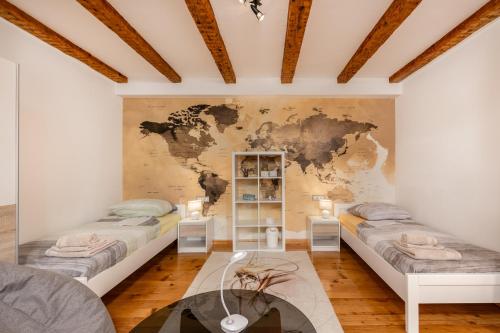 a room with two beds with a map on the wall at Apartment in GREEN with private SAUNA and WHIRLPOOL Bathtube in Matulji