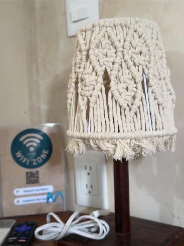 a knitted lamp sitting on a table next to a box at Hotel & Eco Cabañas Azul María Bacalar- Gratis Club de playa in Bacalar