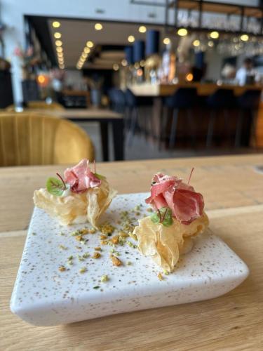 two pieces of food on a plate on a table at Waterresort Bodelaeke Giethoorn in Giethoorn