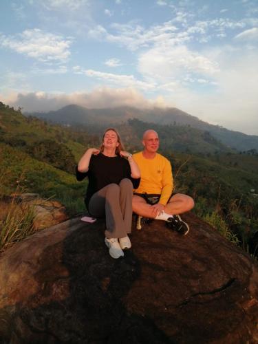 a man and a woman sitting on top of a rock at Awesome Place in Ella