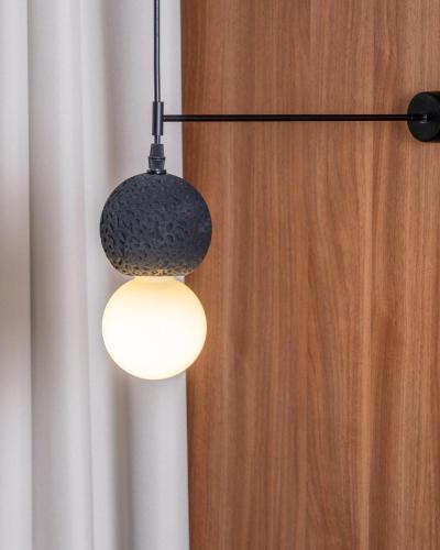 a black and white light hanging from a wall at Cardo Roma, Autograph Collection in Rome
