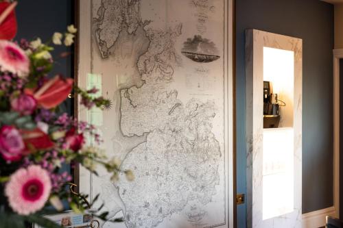 a map hanging on a wall with flowers on it at Aynsome Manor in Cartmel