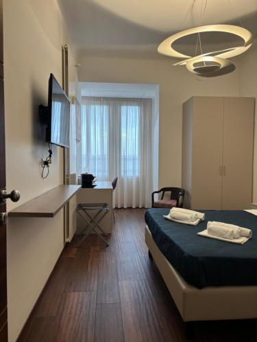 a room with a bed and a desk and a kitchen at Enjoy Milano Skyline in Milan
