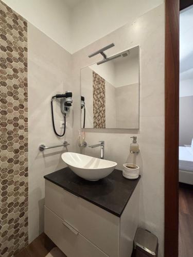 a bathroom with a sink and a mirror at Enjoy Milano Skyline in Milan
