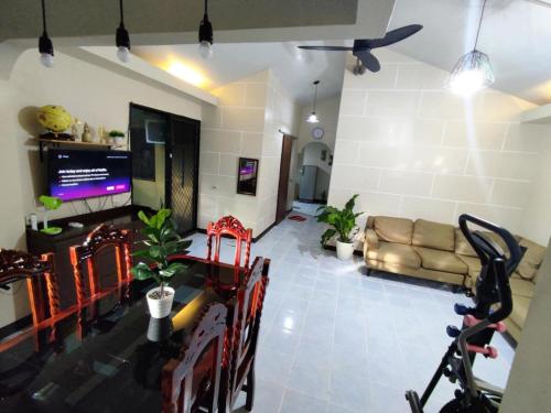 a living room with a couch and a television at Ranks Homestay in Cagayan de Oro
