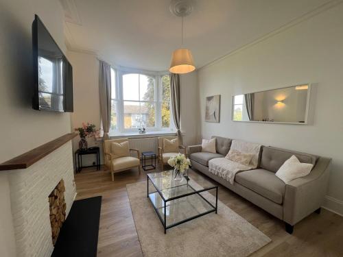 a living room with a couch and a fireplace at Hurstpier Spacious 2 Bed Apartment - by MCF in Hurstpierpoint