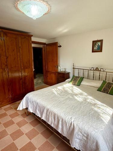 a bedroom with a large bed and a chandelier at Casa Mary in Lucca