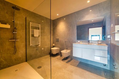 a bathroom with a sink and a toilet and a shower at Quinta de Casal do Bairro Casa Grande in Guimarães