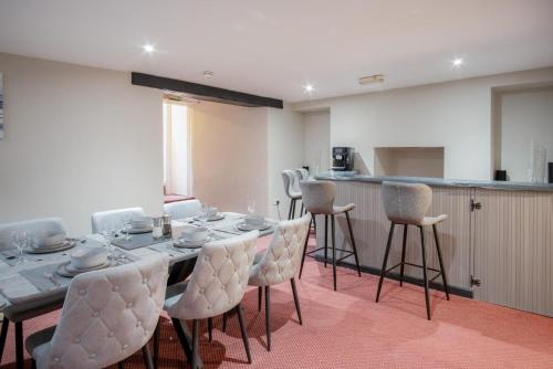 a dining room with a long table and chairs at The Lanterns - 9 Bedroom - Sleeps 17 - Saundersfoot Village Centre in Saundersfoot