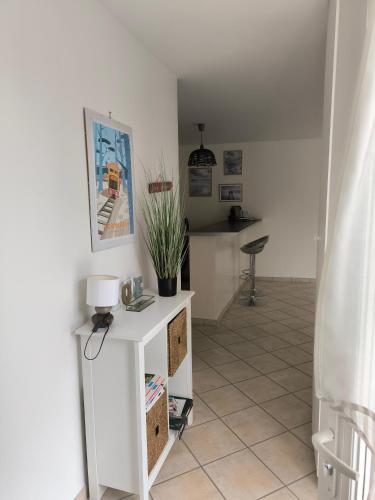 - un salon avec une table et une plante dans l'établissement Maison indépendante en plein cœur de Dolus, à Dolus-d'Oléron