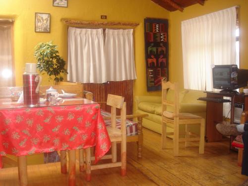 a living room filled with furniture and a table at Samay Wasi Hostel I in Cusco