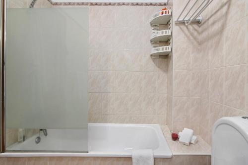 a bathroom with a shower with a tub and a sink at Casa Oliveira in Conceição