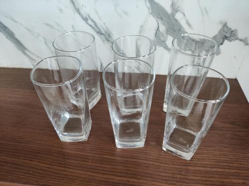 a group of four clear glasses sitting on a table at Siva Rama garden resort & swimming pool 5star stay comfort 6BHK bheemili beach road nr in Visakhapatnam