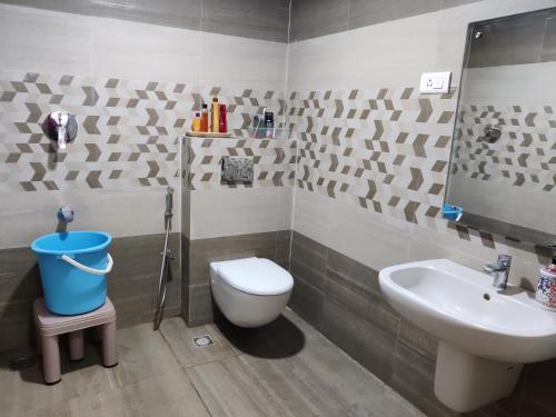 a bathroom with a toilet and a sink at Siva Rama garden resort & swimming pool 5star stay comfort 6BHK bheemili beach road nr in Visakhapatnam