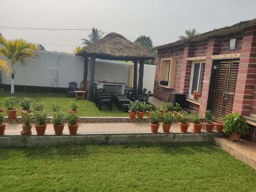 a house with a patio with potted plants at Siva Rama garden resort & swimming pool 5star stay comfort 6BHK bheemili beach road nr in Visakhapatnam