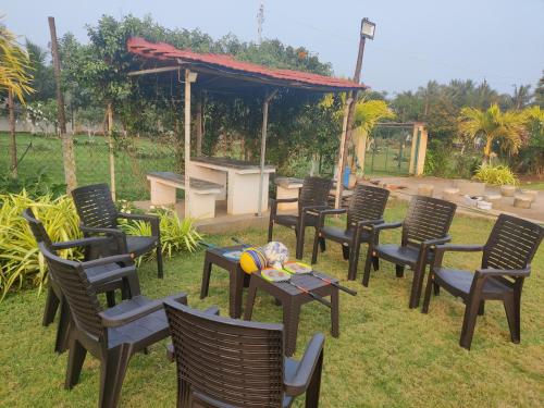 a group of chairs and tables in a yard at Siva Rama garden resort & swimming pool 5star stay comfort 6BHK bheemili beach road nr in Visakhapatnam
