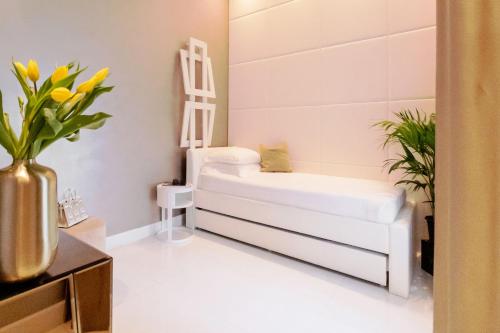 a living room with a white couch and flowers at Domus Aurea Luxury Suites in Rome