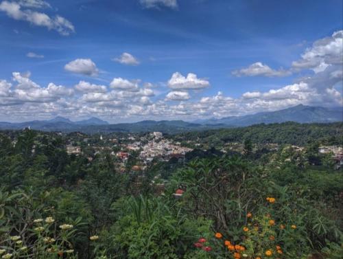 a view of a city with mountains and trees at Namadi heights Bungalow in Kandy