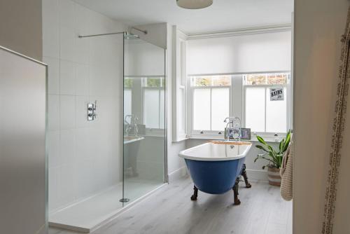 a bathroom with a bath tub and a shower at Warwick Villa in Walmer