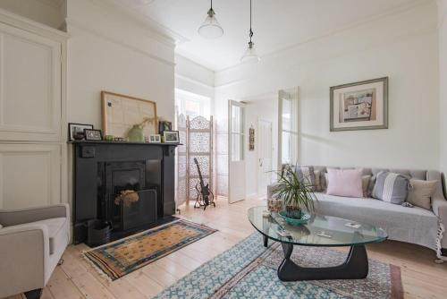 a living room with a couch and a fireplace at Warwick Villa in Walmer