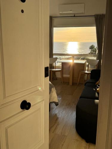 a door leading to a living room with a view of the ocean at The View Calahonda Primera Línea de Playa y Vistas Panorámicas in Mijas Costa