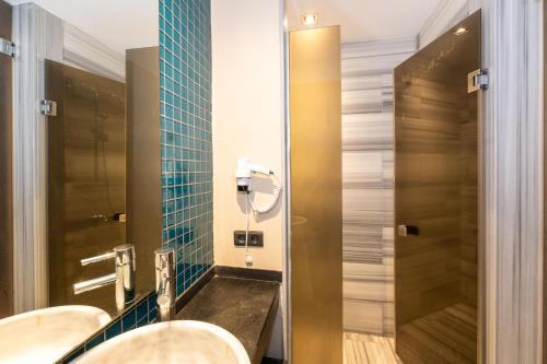 a bathroom with two toilets and a mirror at Pera Tulip Hotel & Spa - Istanbul Taksim Pera City Center in Istanbul