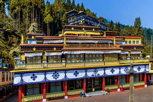a large building with a red and yellow at Hotel O Demadzong in Gangtok