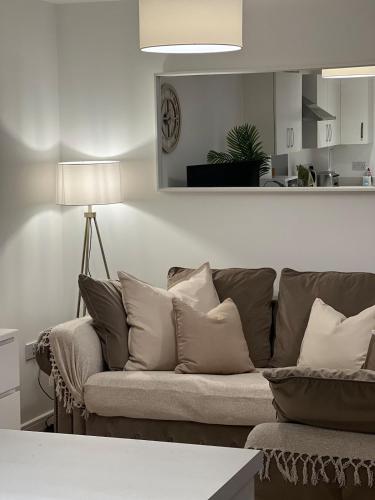 a living room with a couch with pillows at Spacious 2 Bed, 2 Bath Apartment by MCF in Horley