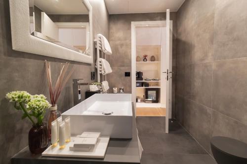 a bathroom with a white tub and a sink at Domus Aurea Luxury Suites in Rome