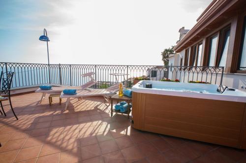 a hot tub on the balcony of a house at Amalfi House Marlidia in Conca dei Marini