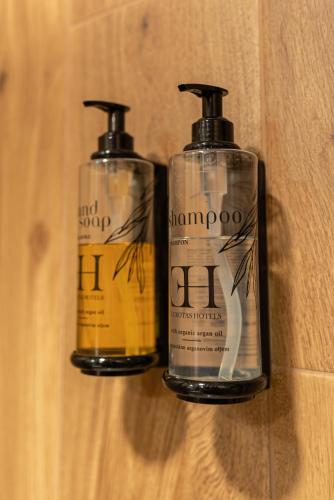 two bottles of soap sitting on a wall at Hotel Kranjska Gora in Kranjska Gora