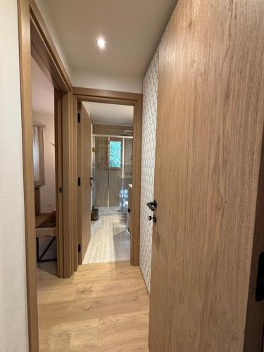 a hallway with a door leading into a room at Appartamento nuovo Sankt Moritz Chesa arlas 3B in St. Moritz